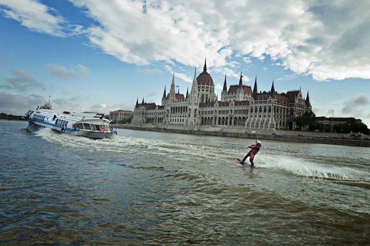 Kinga is riding behind a hydrofoil